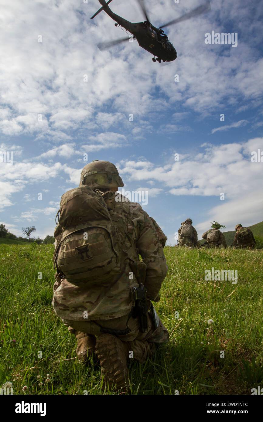 U.S. Army Soldiers await the arrival of a medevac during air assault training in Gracanica, Kosovo. Stock Photo