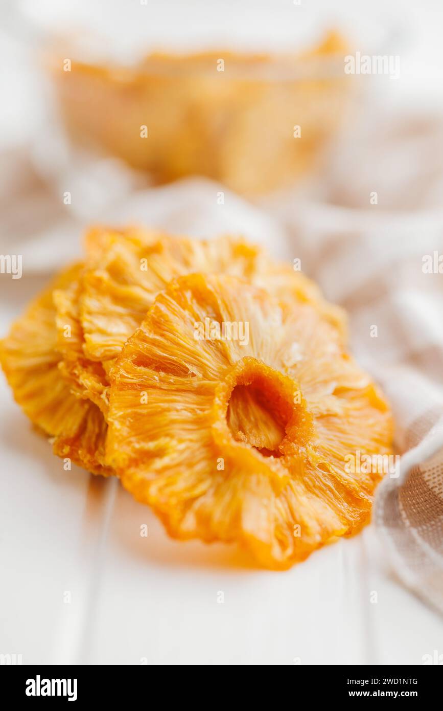 Dried pineapple rings on the white table. Stock Photo