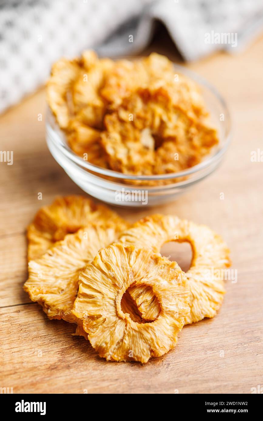 Dried pineapple rings on the wooden table. Stock Photo