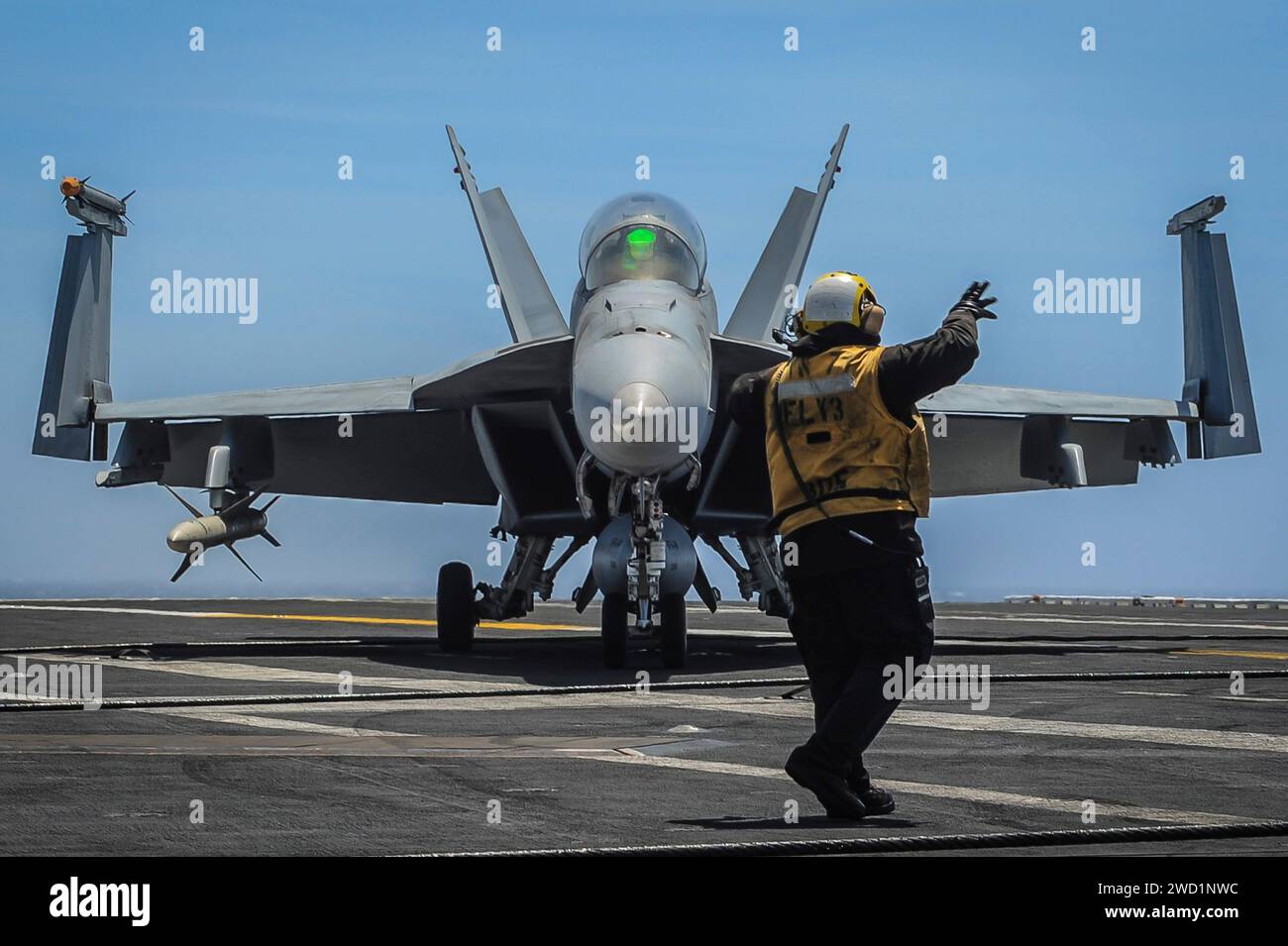 An F/A-18F Super Hornet drives to a catapult prior to launch on the flight deck of USS Theodore Roosevelt. Stock Photo