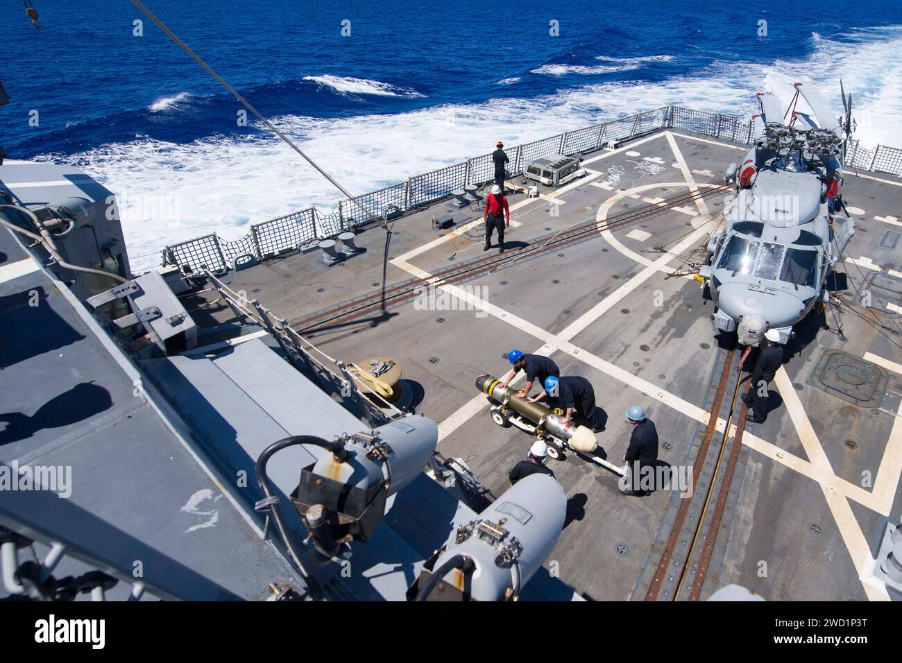 Sailors transport a Mark 46 Mod 5A torpedo across the flight deck of ...