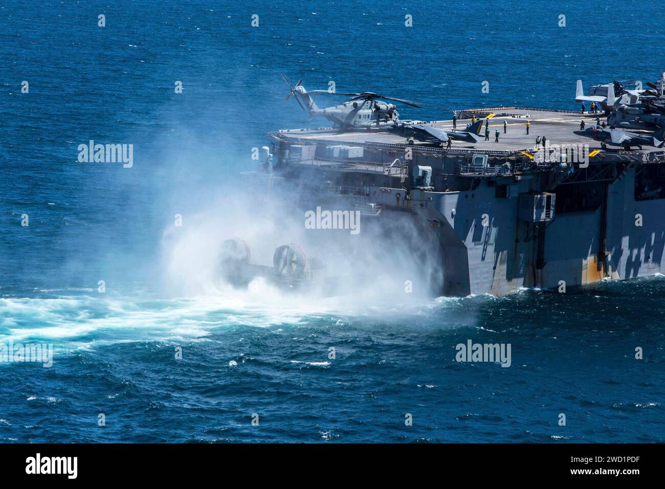 A landing craft, air cushion enters the well deck of the amphibious ...