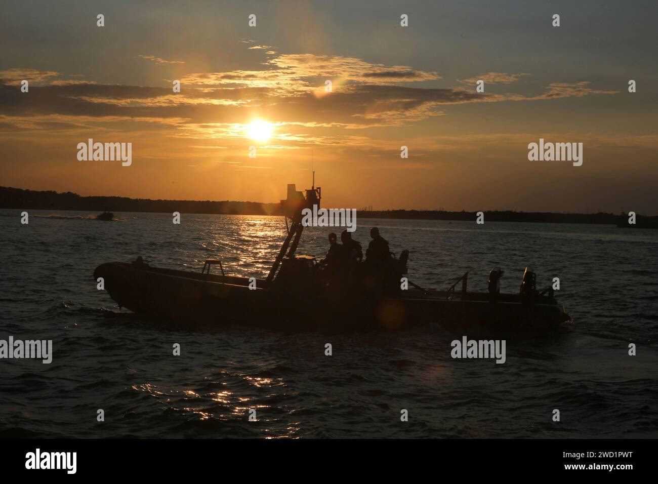 Sailors drive a rigid-hull inflatable boat during visit, board, search and seizure training. Stock Photo