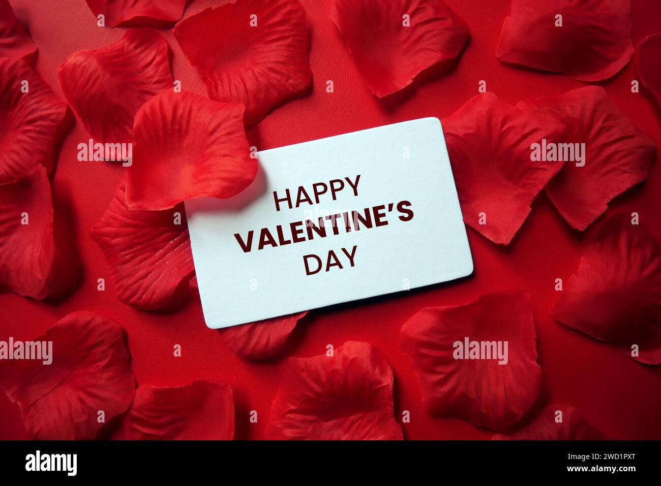 Happy Valentine's Day card with red rose petals sprinkled. Romantic ...