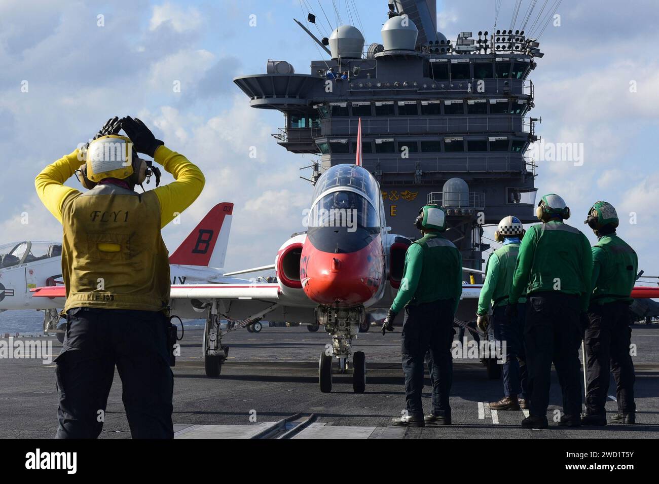 Sailors position a T-45C Goshawk training aircraft on a catapult aboard ...
