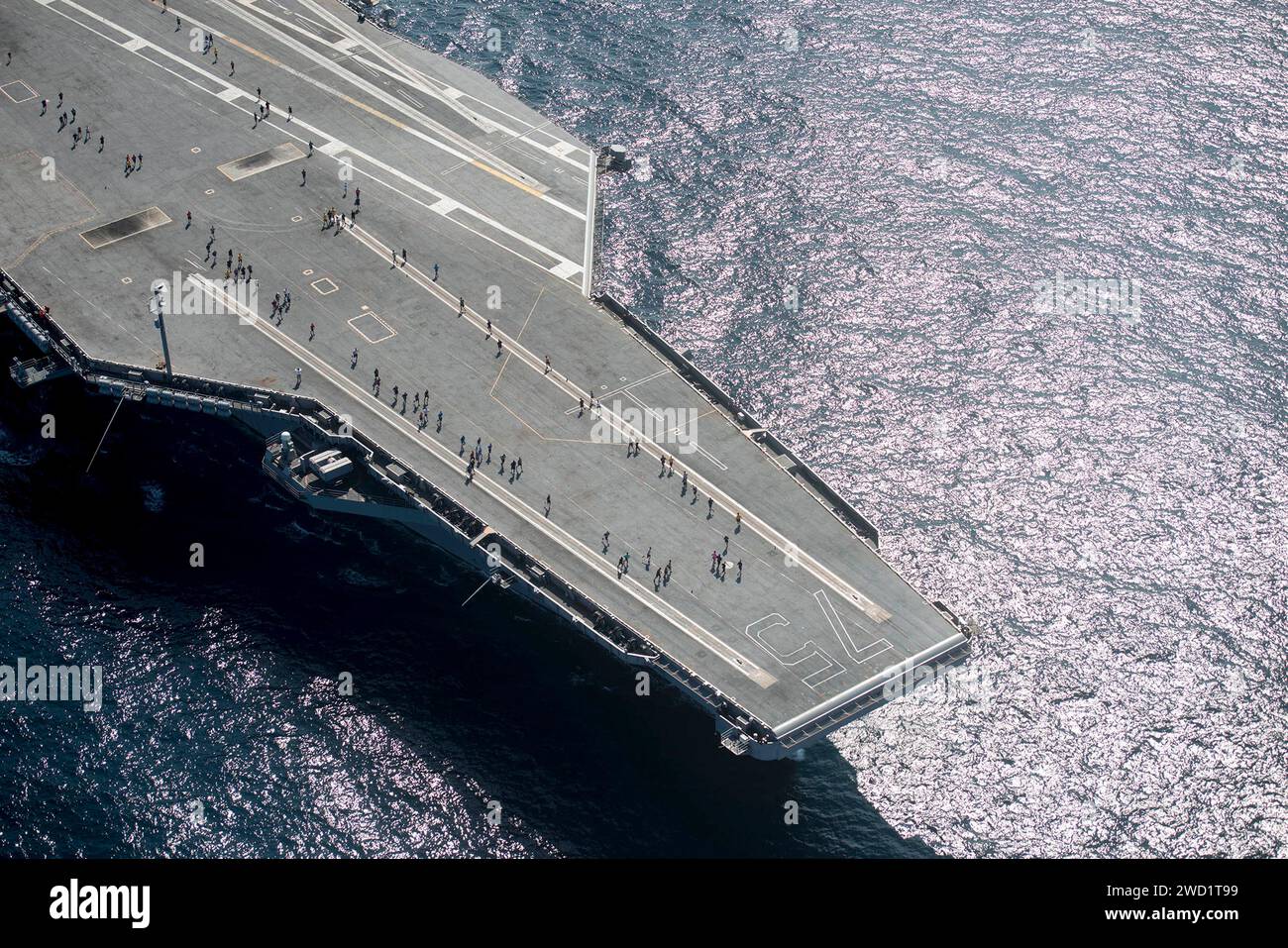 Sailors participate in a 5 kilometer run on the flight deck aboard the aircraft carrier USS Harry S. Truman. Stock Photo