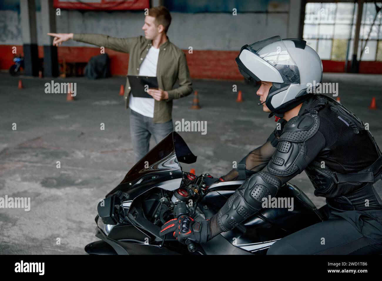 Driving practice at motorcycle driver training center with indoor