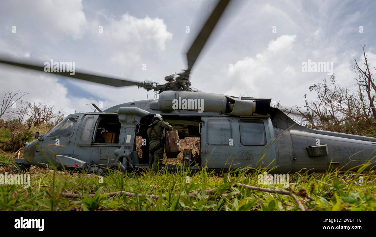 Naval Aircrewman loads luggage into an MH-60S Sea Hawk helicopter Stock ...