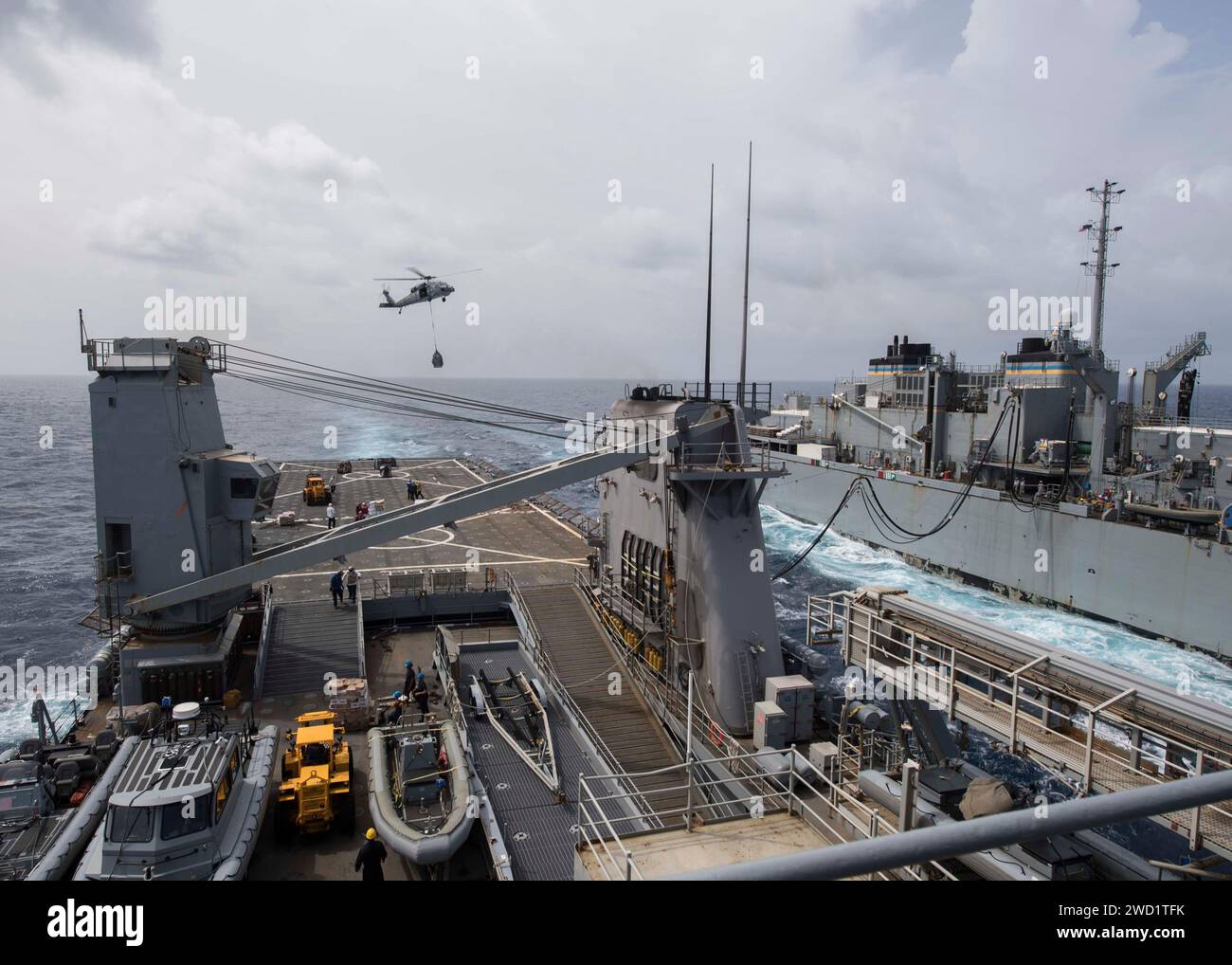 Dock landing ship USS Oak Hill conducts a replenishment-at-sea with the fast combat support ship USNS Supply. Stock Photo