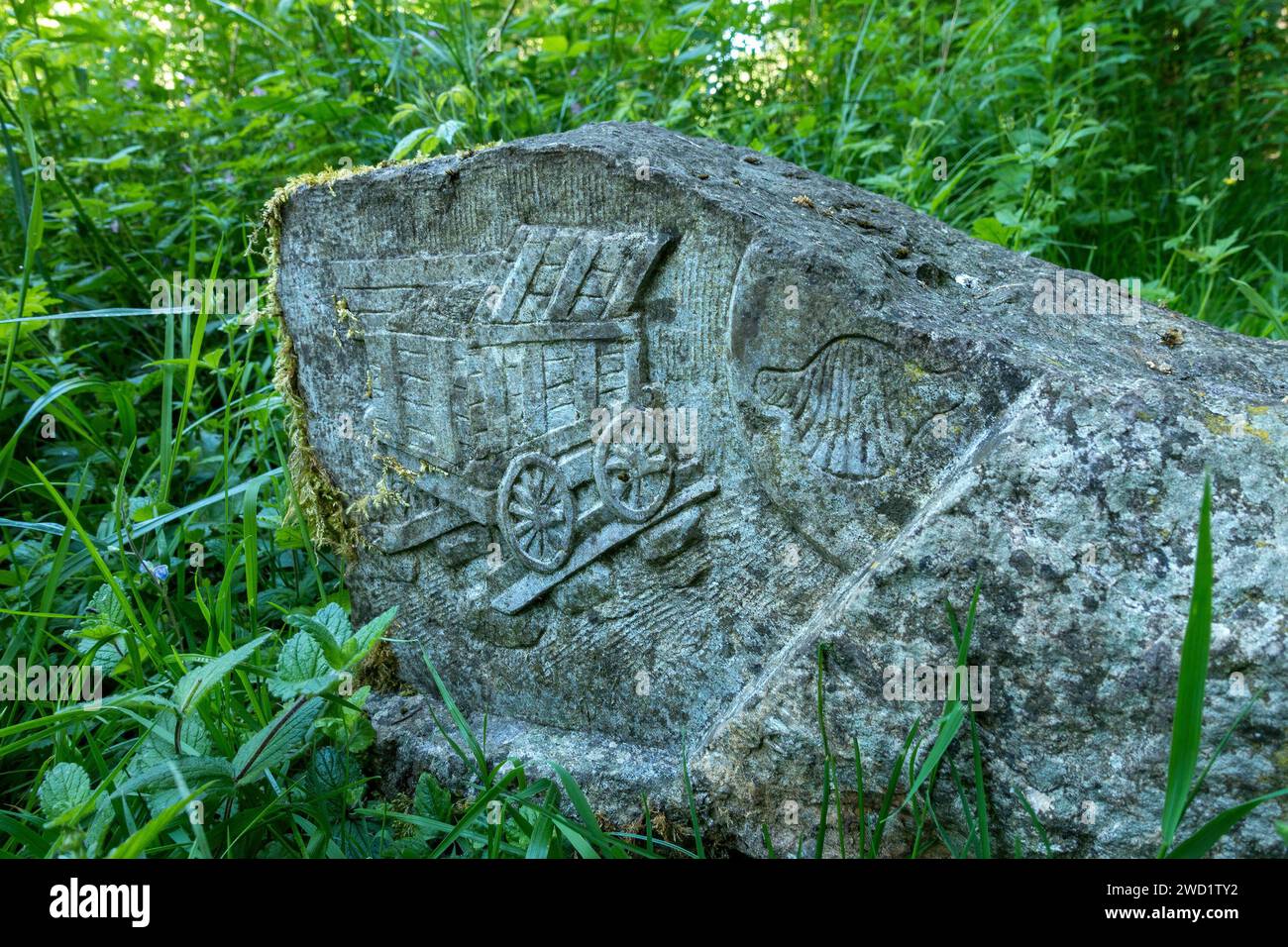Carved stone depicting a wagon used to transport quarried limestone on the tramway / railway at Ticknall Limeyards / Quarry, Derbyshire, England, UK Stock Photo