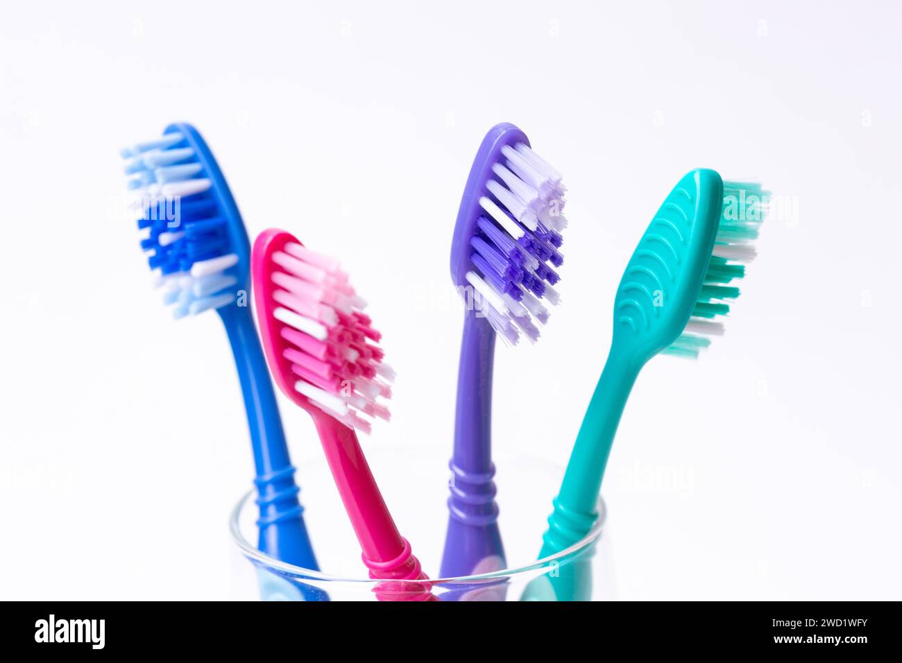 Four colourful plastic toothbrushes Stock Photo