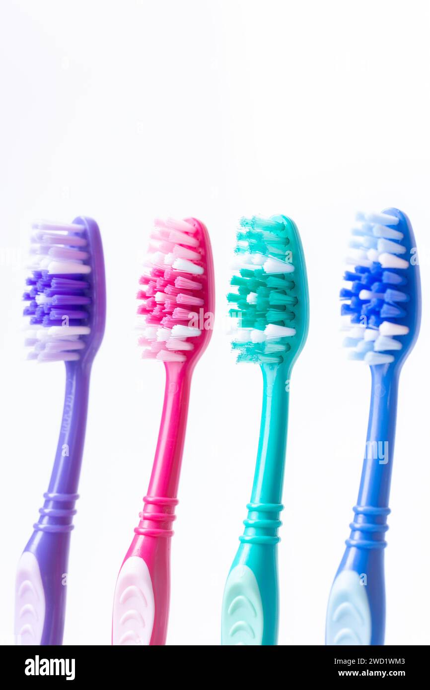 Four colourful plastic toothbrushes Stock Photo