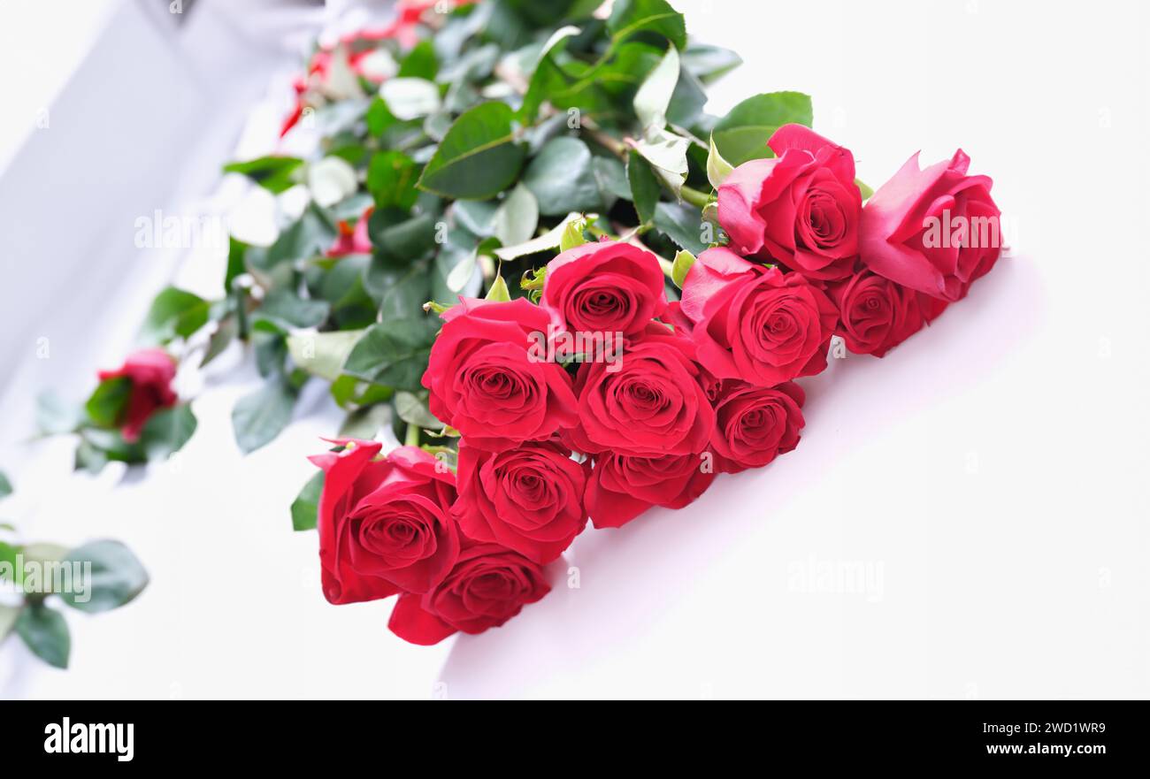Beautiful bouquet of red roses lies on white background Stock Photo - Alamy