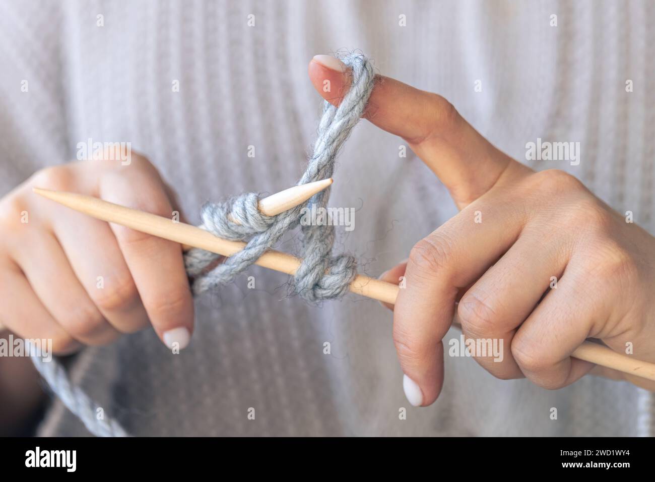Close-up of hands knitting using circular needles. Stock Photo