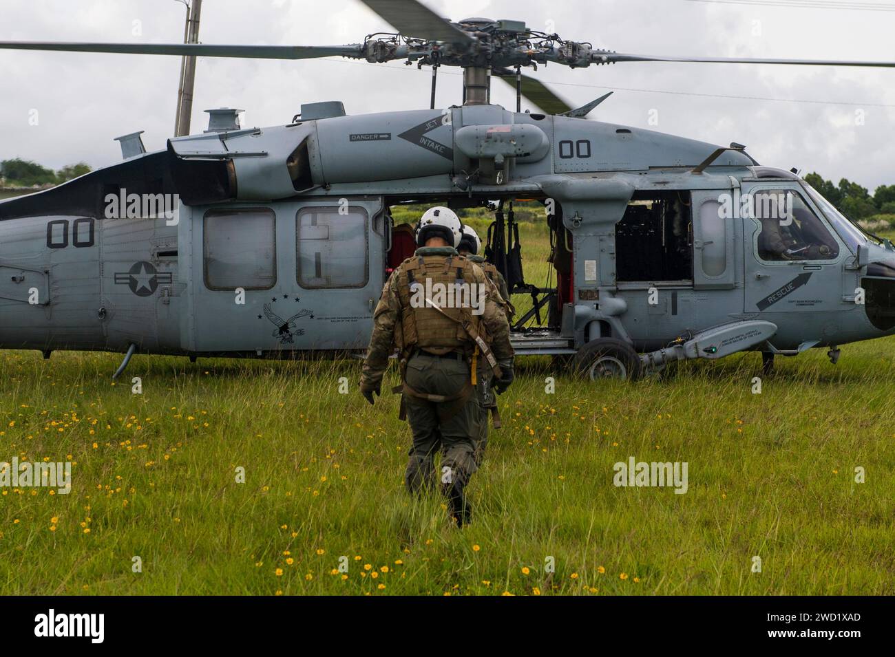 Naval aircrewman boarding a MH-60S Knighthawk helicopter. Stock Photo