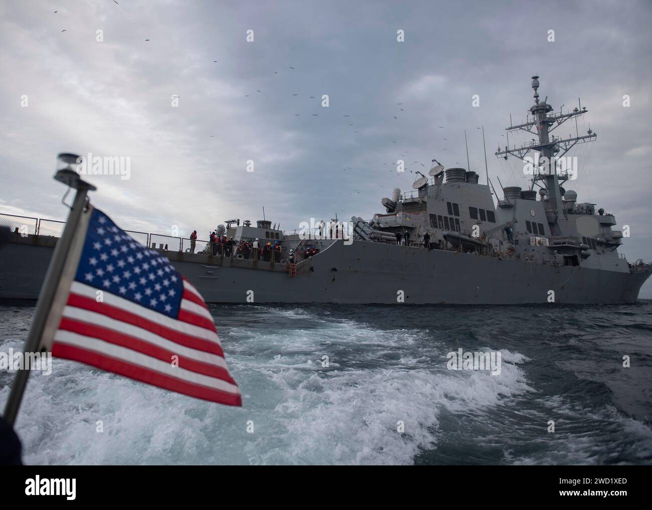 A rigid-hull inflatable boat departs the guided-missile destroyer USS Donald Cook. Stock Photo