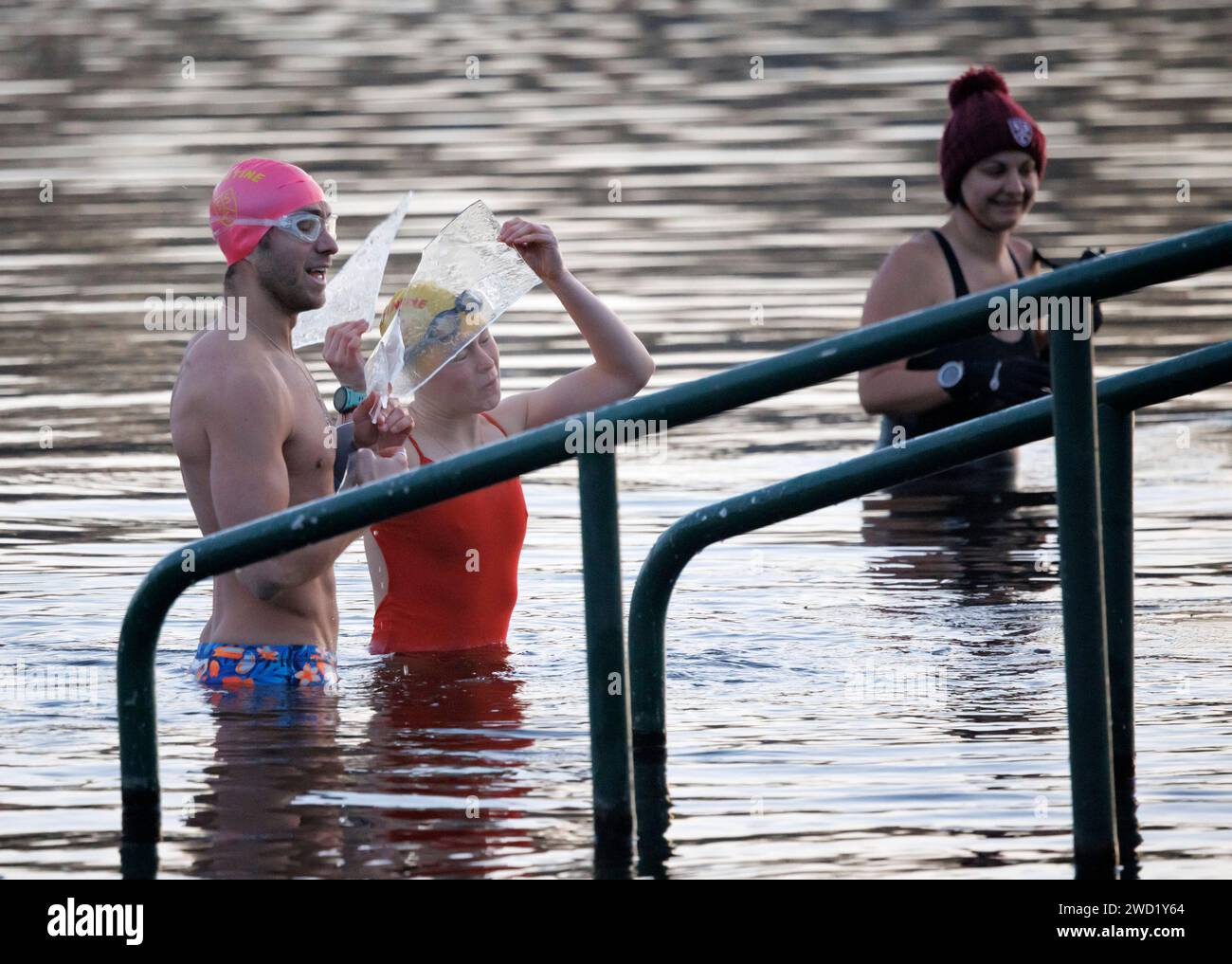 London, UK. 18th Jan, 2024. Early morning swimmers hold up shards of ice as they take to the Serpentine Lake in Hyde Park, central London, frozen over as temperatures in the capital drop below zero for another night. Amber and Yellow weather warnings for snow and ice have been issued by The Met Office for large parts of the UK. Photo credit: Ben Cawthra/Sipa USA Credit: Sipa USA/Alamy Live News Stock Photo