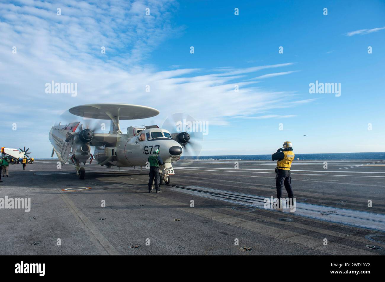 An E-2C Hawkeye prepares to take off from the flight deck of USS Dwight D. Eisenhower. Stock Photo