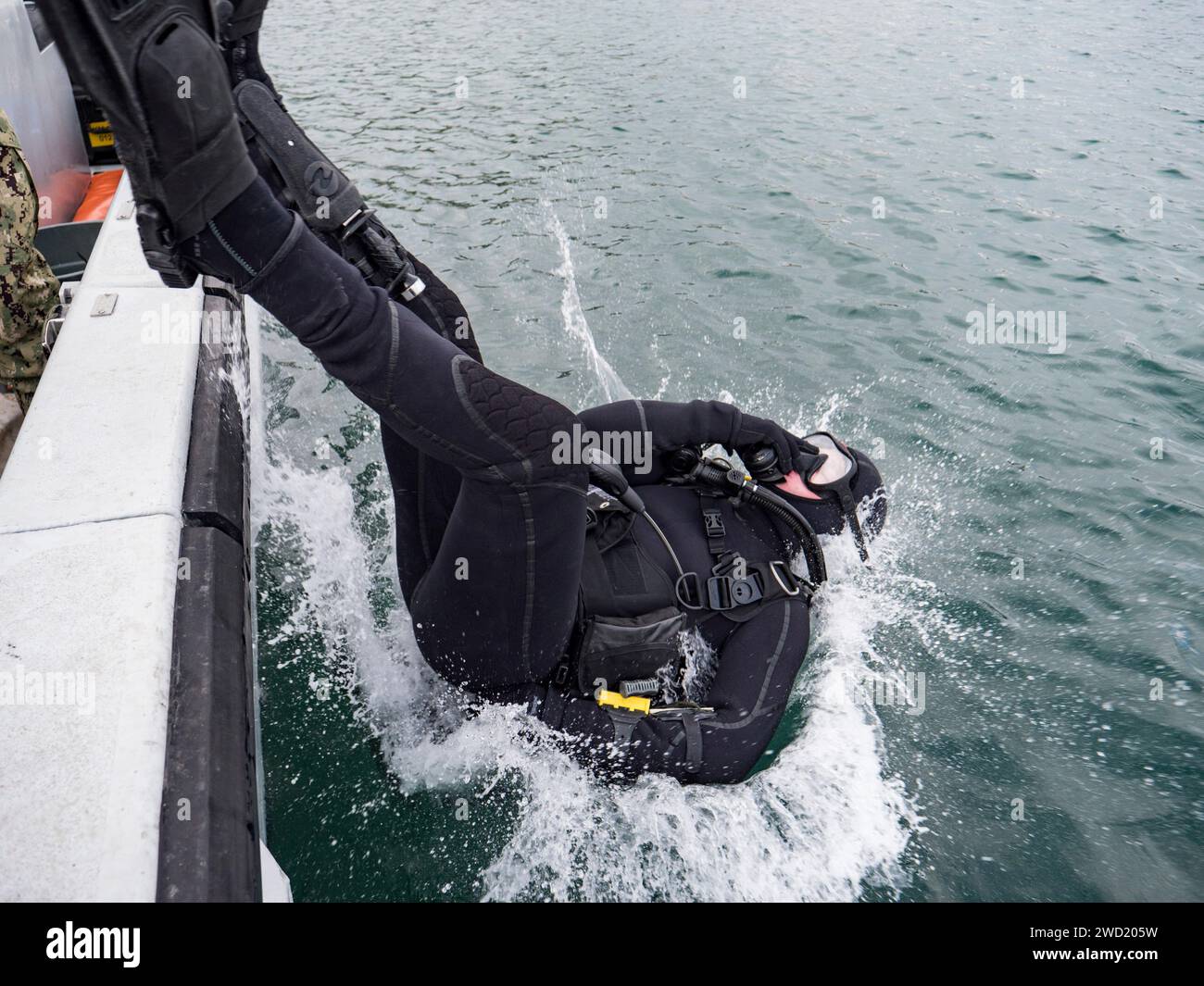 U.S. Navy diver enters the water for a mooring buoy inspection at Commander, Fleet Activities Sasebo, Japan. Stock Photo