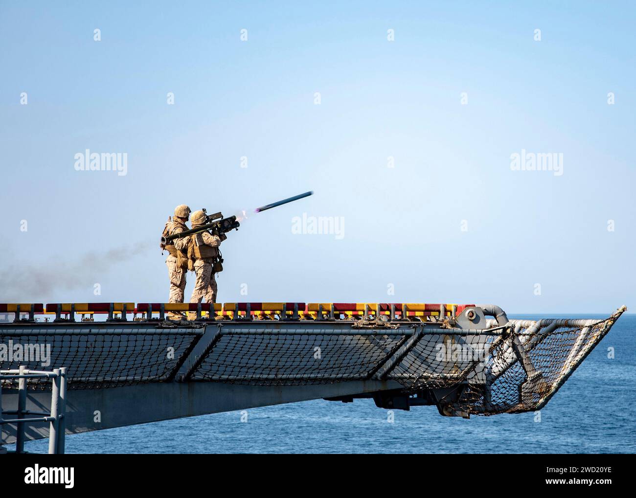 U.S. Marine fires a FIM-92 Stinger anti-aircraft missile from the flight deck of USS Essex. Stock Photo