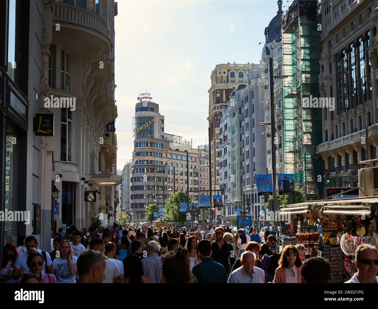 Throng or crowd of people on the Gran Via in the Spanish Capital city. Rush hour in Madrid with big crowd running in the city downtown. Madrid, Spain Stock Photo