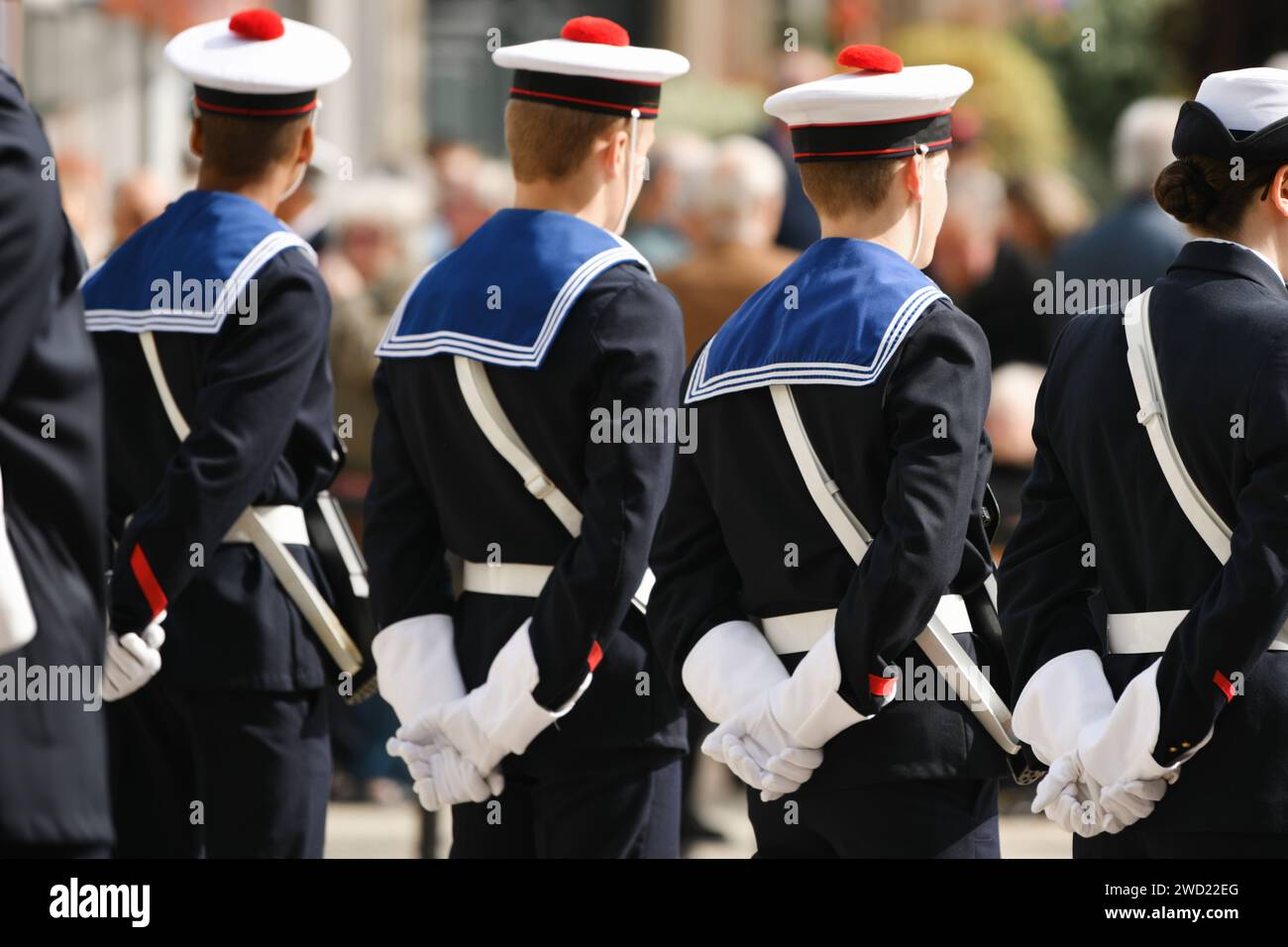 French sailors in white gloves and berets with a red pompom. french marine cap. 8 May Stock