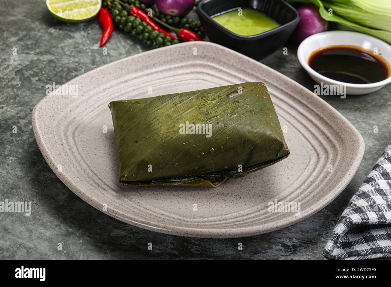 Asian cuisine - rice with filling wrapped in banana leaf Stock Photo ...