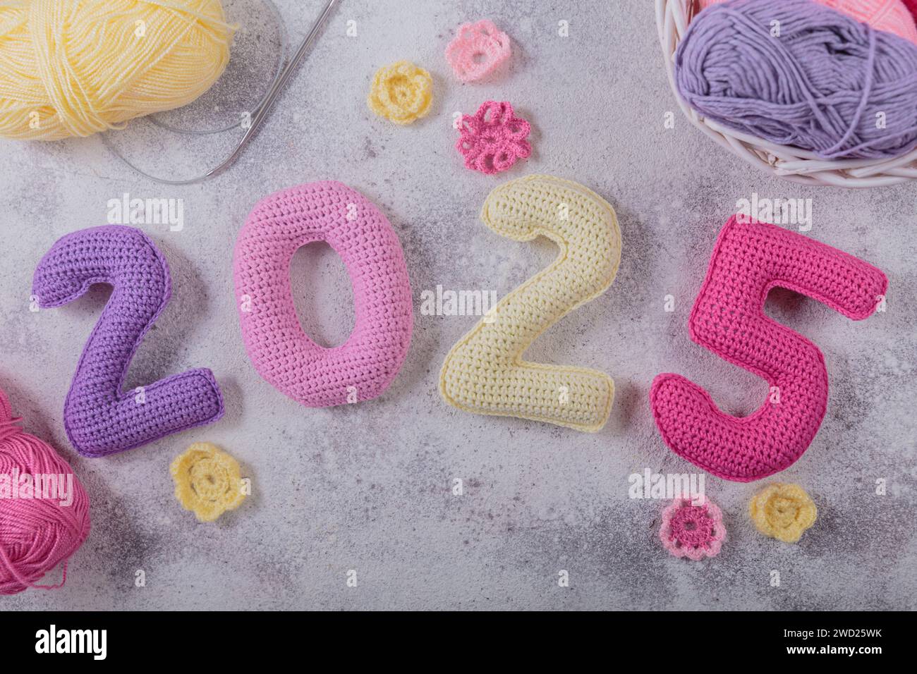 New Years background with multicolored crochet numbers 2025 Stock Photo