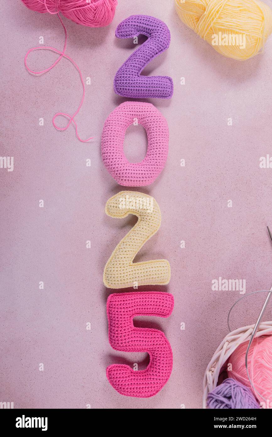 New Years background with multicolored crochet numbers 2025 Stock Photo
