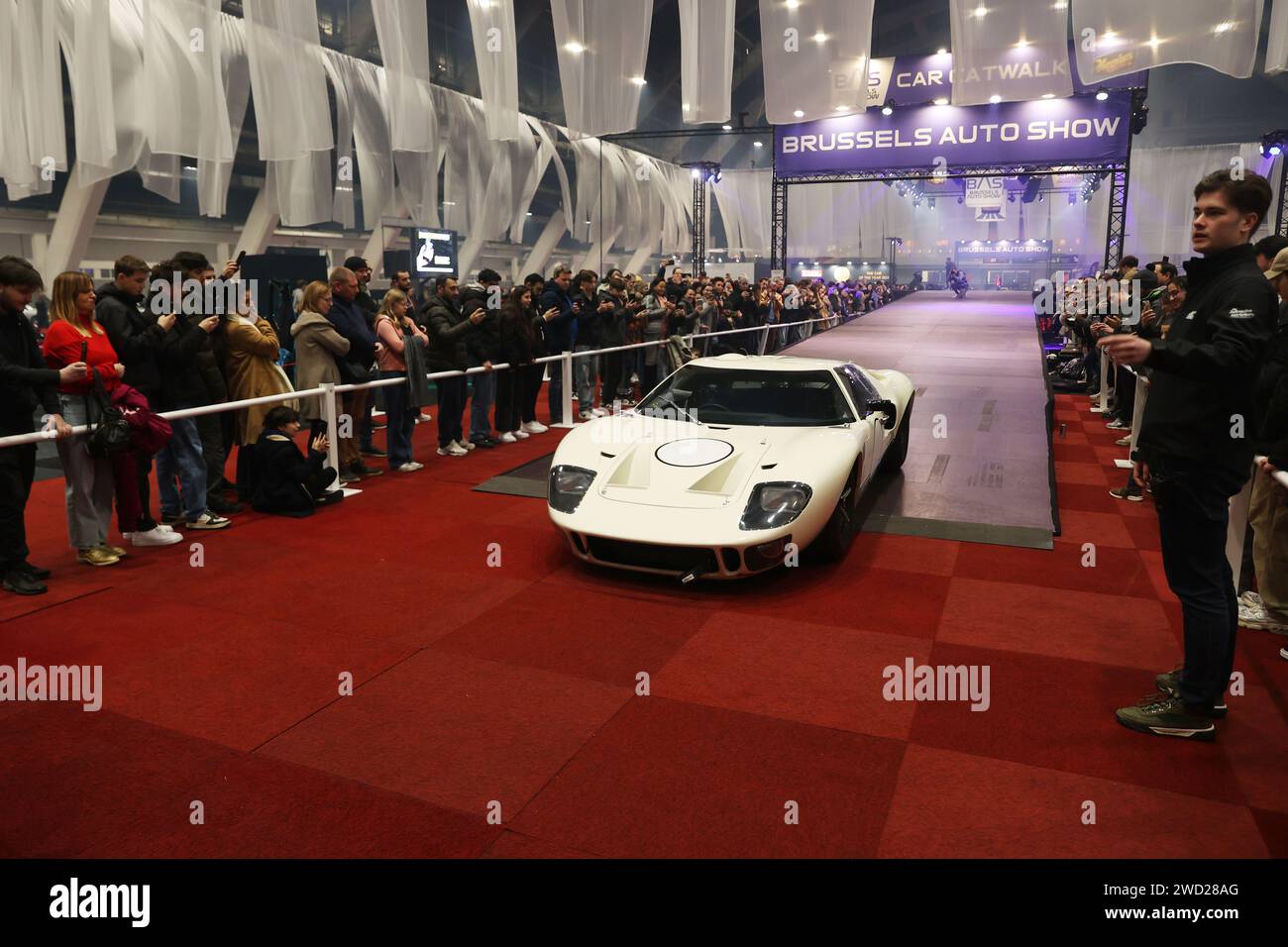 Brussels, Belgium. 17th Jan, 2024. Visitors watch a show for cars at Brussels Auto Show in Brussels, Belgium, Jan. 17, 2024. This year's Brussels Auto Show (BAS) kicked off on Wednesday in the Belgian capital, presenting over 400 cars, motorcycles, and trucks from more than 150 companies, putting sustainable mobility in the limelight. Credit: Zhao Dingzhe/Xinhua/Alamy Live News Stock Photo