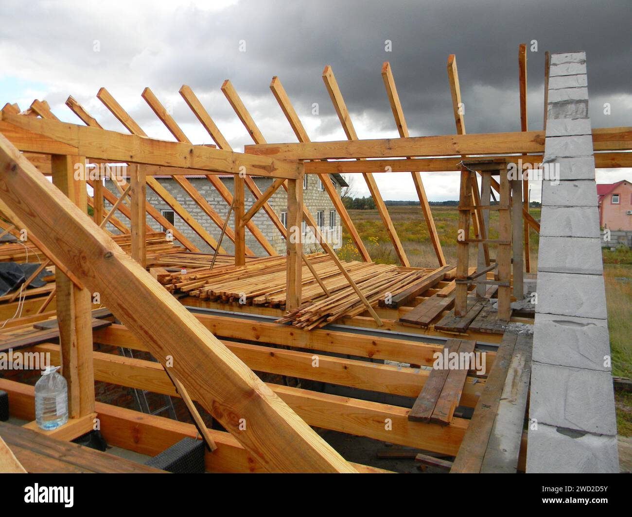 Roofing construction a close up on an unfinished roof framing with wooden ceiling joists, roof