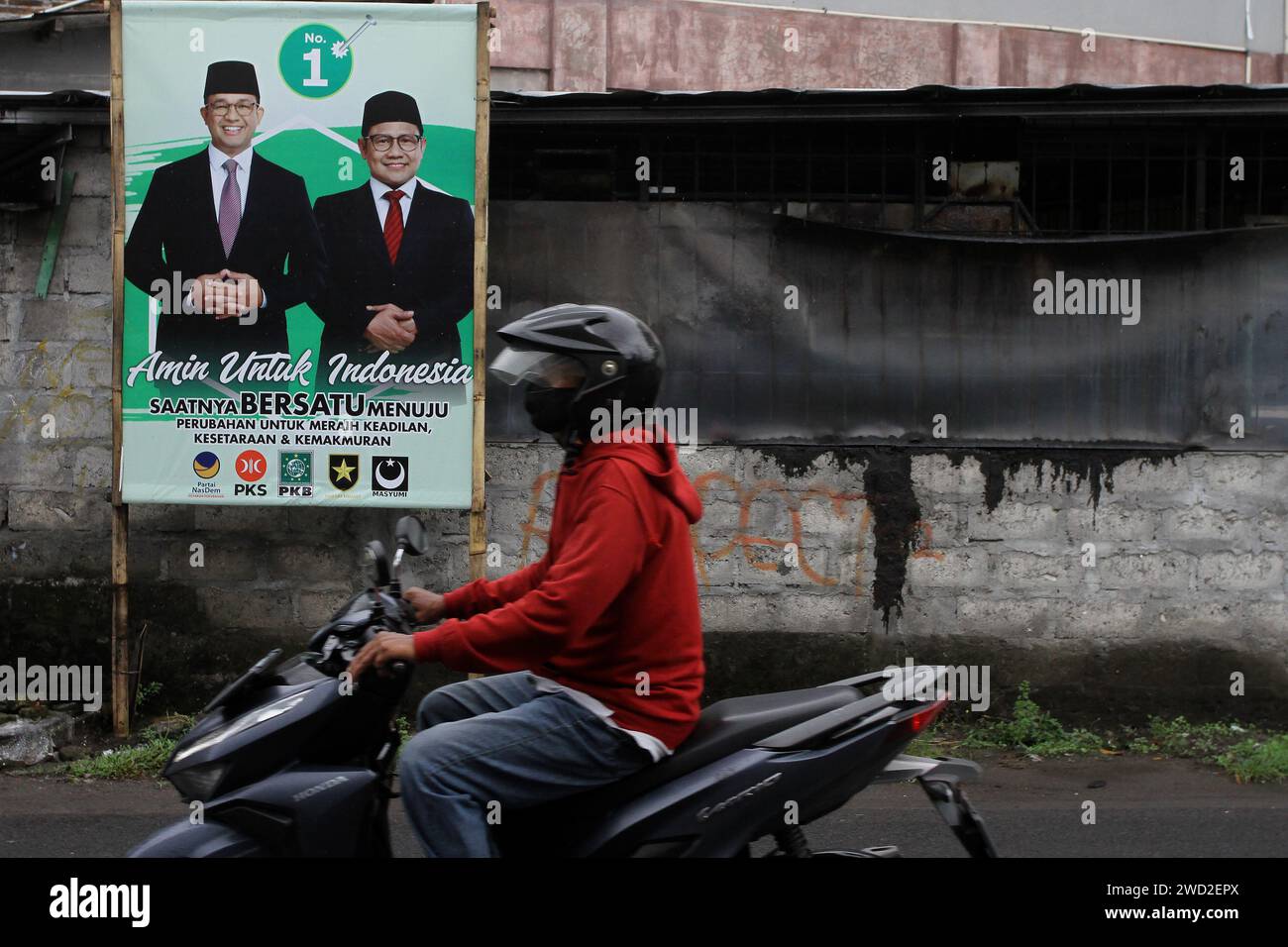 Sleman, Yogyakarta, Indonesia. 18th Jan, 2024. A motorcyclist pass the banner of Presidential Candidate, Anies Baswedan, and his running mate, Muhaimin Iskandar, in Sleman, Yogyakarta, ahead of the Indonesian general election on February 14, 2024. (Credit Image: © Angga Budhiyanto/ZUMA Press Wire) EDITORIAL USAGE ONLY! Not for Commercial USAGE! Stock Photo