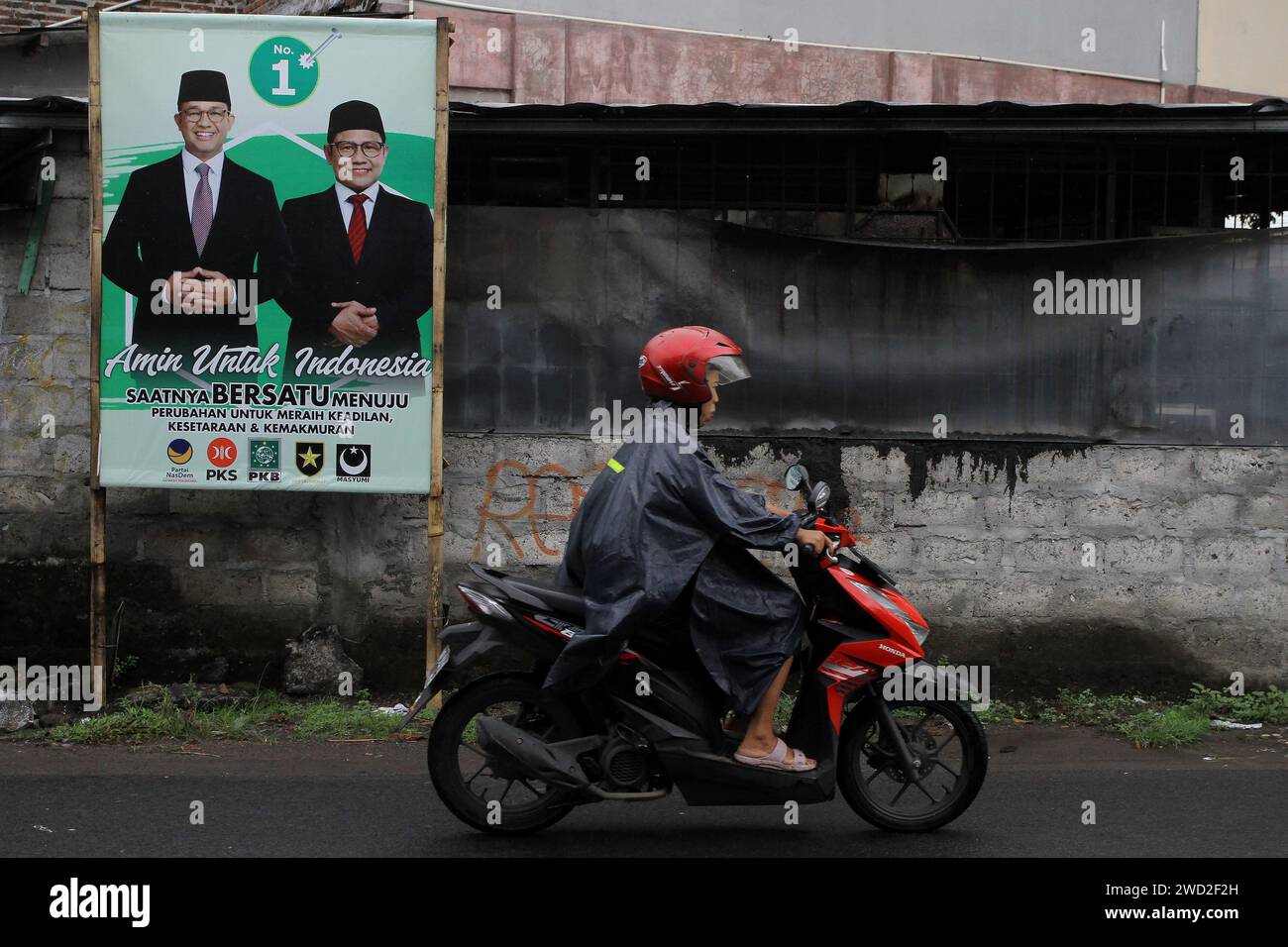 Sleman, Yogyakarta, Indonesia. 18th Jan, 2024. A motorcyclist pass the banner of Presidential Candidate, Anies Baswedan, and his running mate, Muhaimin Iskandar, in Sleman, Yogyakarta, ahead of the Indonesian general election on February 14, 2024. (Credit Image: © Angga Budhiyanto/ZUMA Press Wire) EDITORIAL USAGE ONLY! Not for Commercial USAGE! Stock Photo
