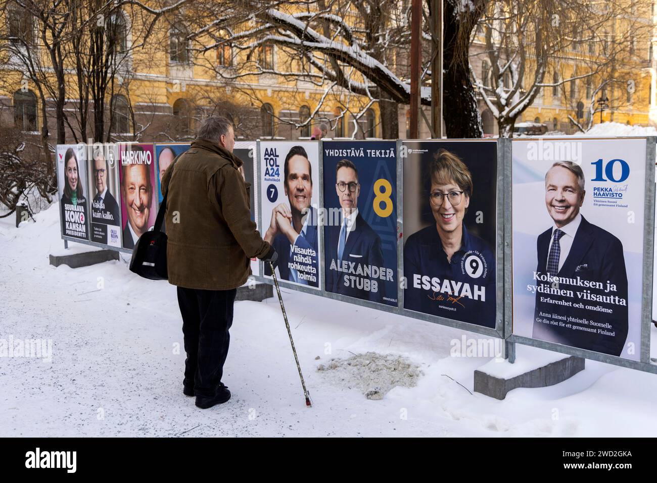Helsinki, Finland. 16th Jan, 2024. A man looks at the campaign posters
