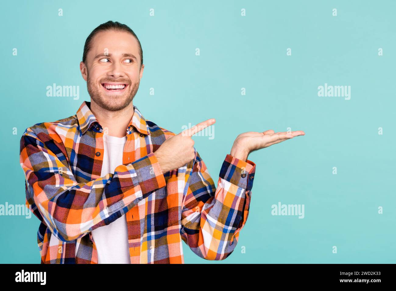 Portrait of toothy beaming guy wear flannel shirt indicating look at ...