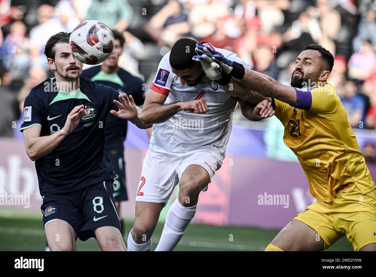 Doha, Qatar. 18th Jan, 2024. Syria's goalkeeper Ahmad Madanieh (R