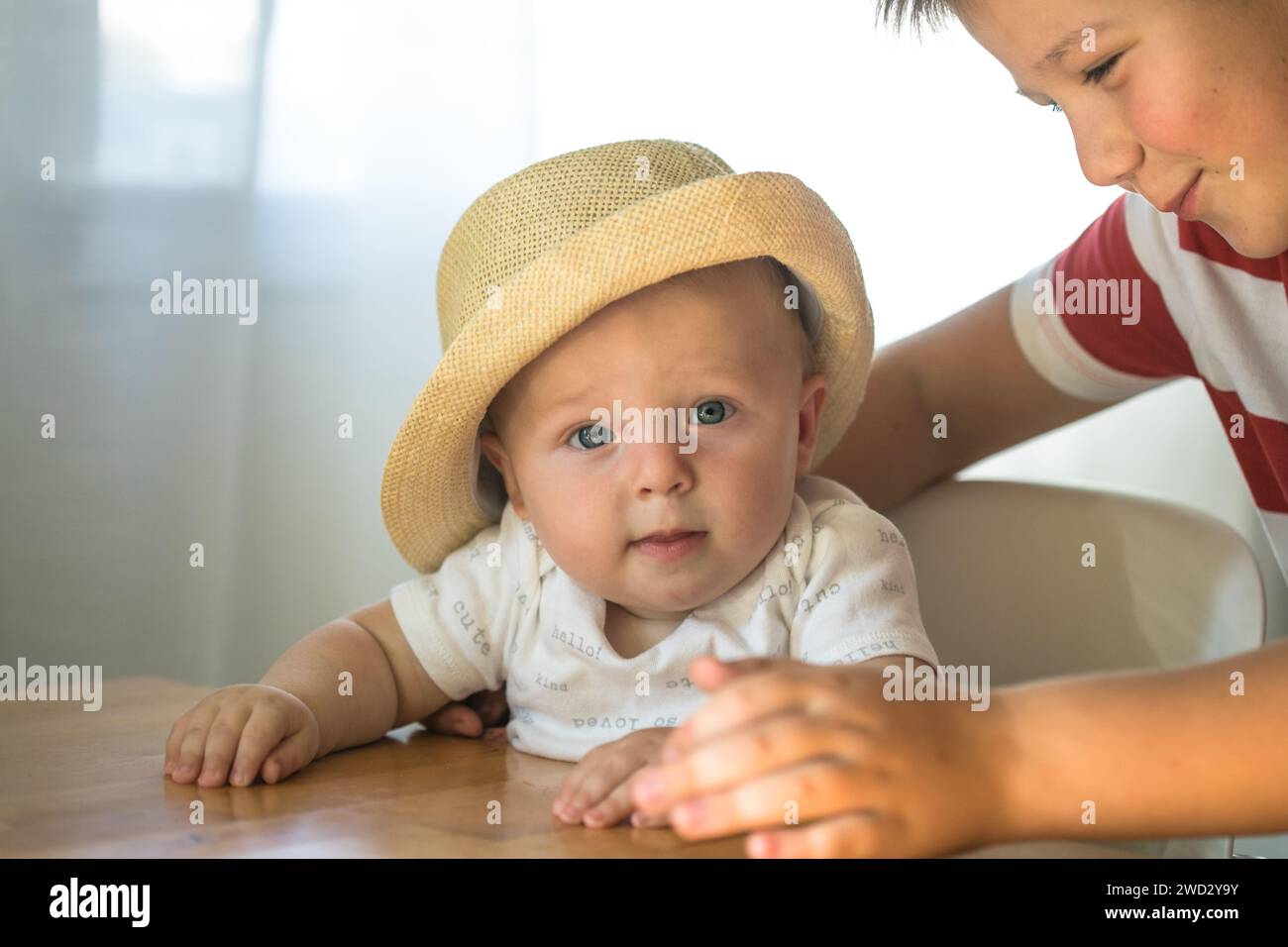 Brother boys hugs younger, taking care of sibling. concept siblings and