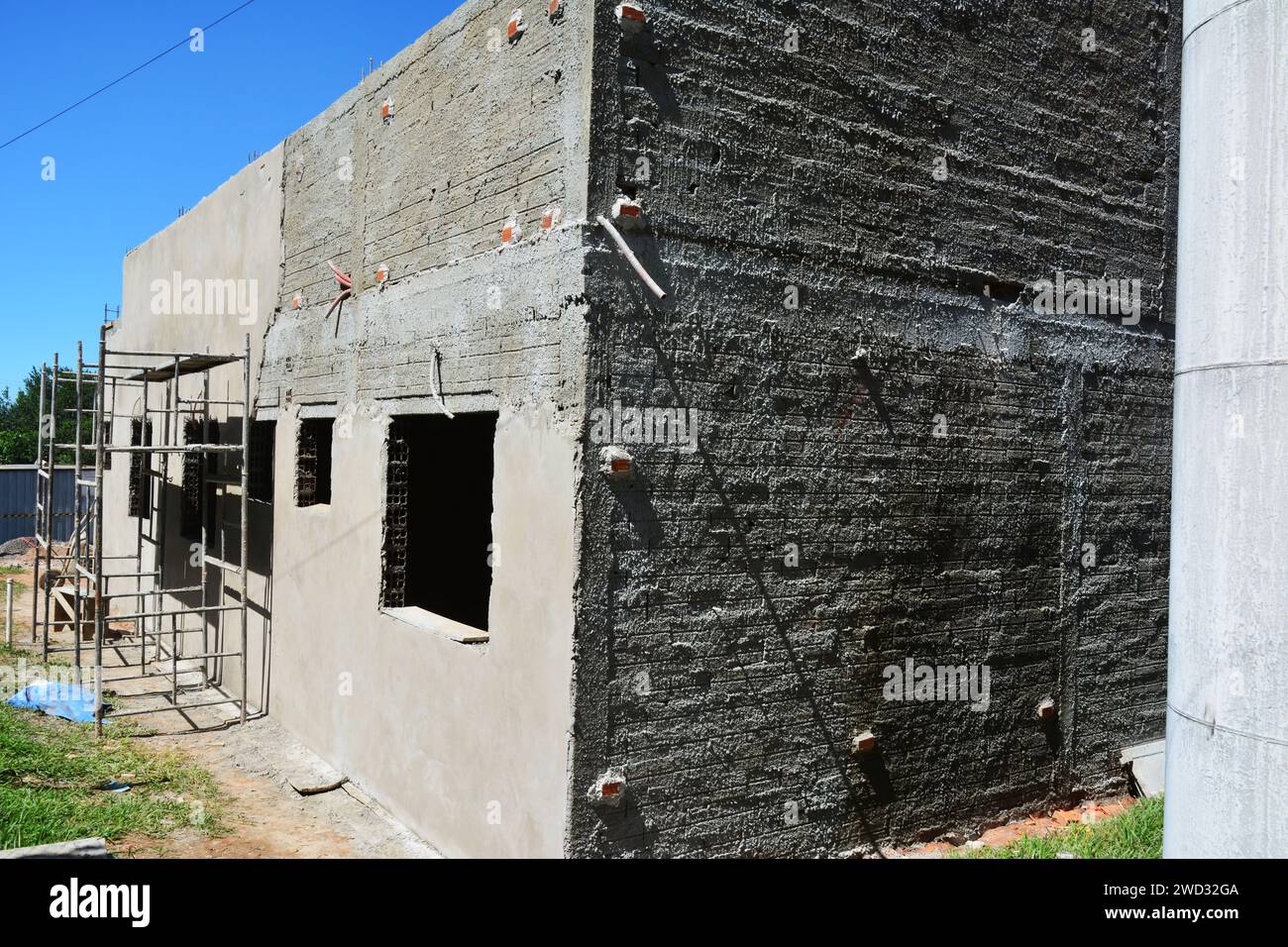 Residential construction with iron scaffolding on construction site
