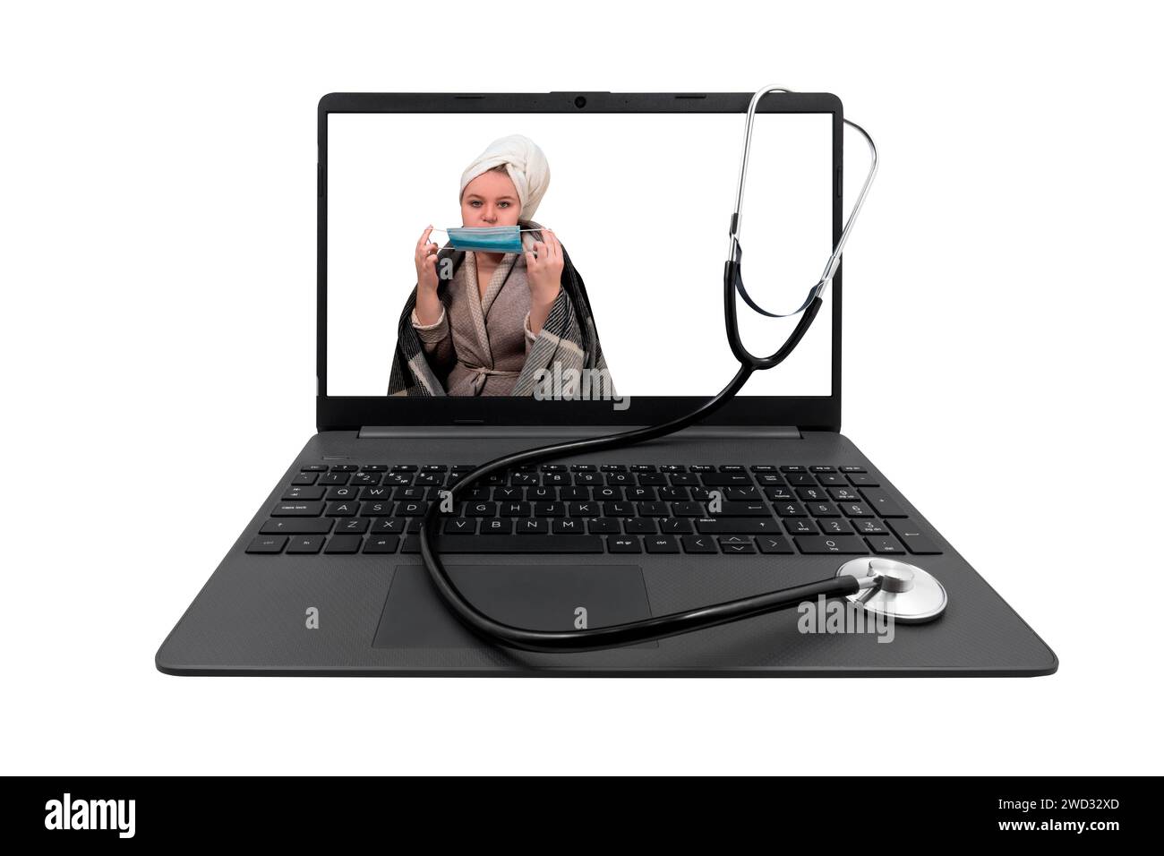 Laptop and medical stethoscope isolated on white background. On laptop screen - a girl with cold symptoms puts a protective medical mask on her face Stock Photo