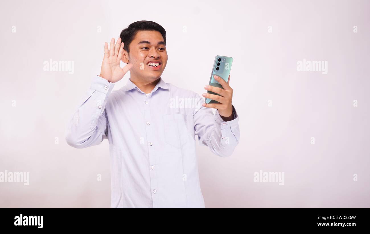 Young Asian Man Make A Video Call with Smartphone on white background Stock Photo