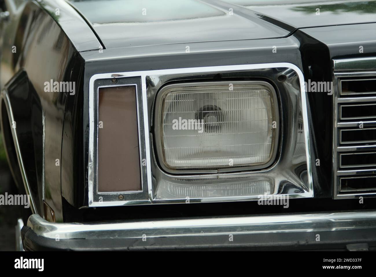 Headlight of an old Buick police patrol car, daytime close-up photo, without people, Buenos Aires, Argentina Stock Photo