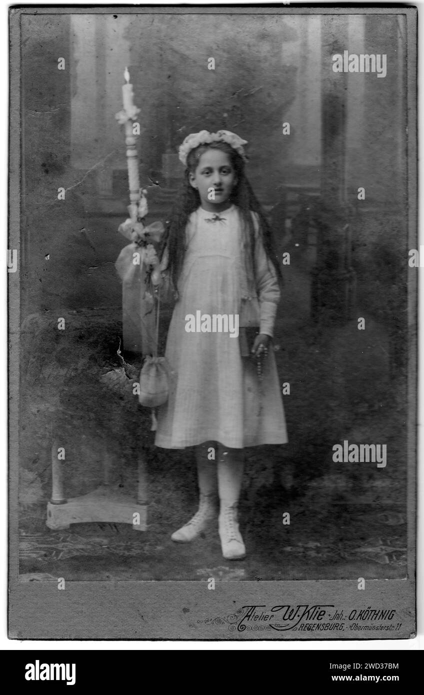 Studio full-length portrait of a girl in a white dress with a wreath on ...