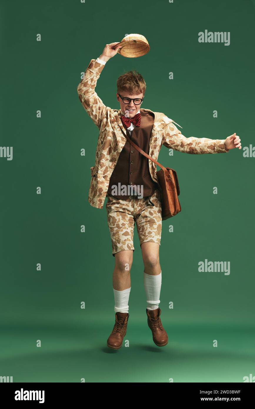 Fulllength image of young guy in retro clothes in image of boy scout