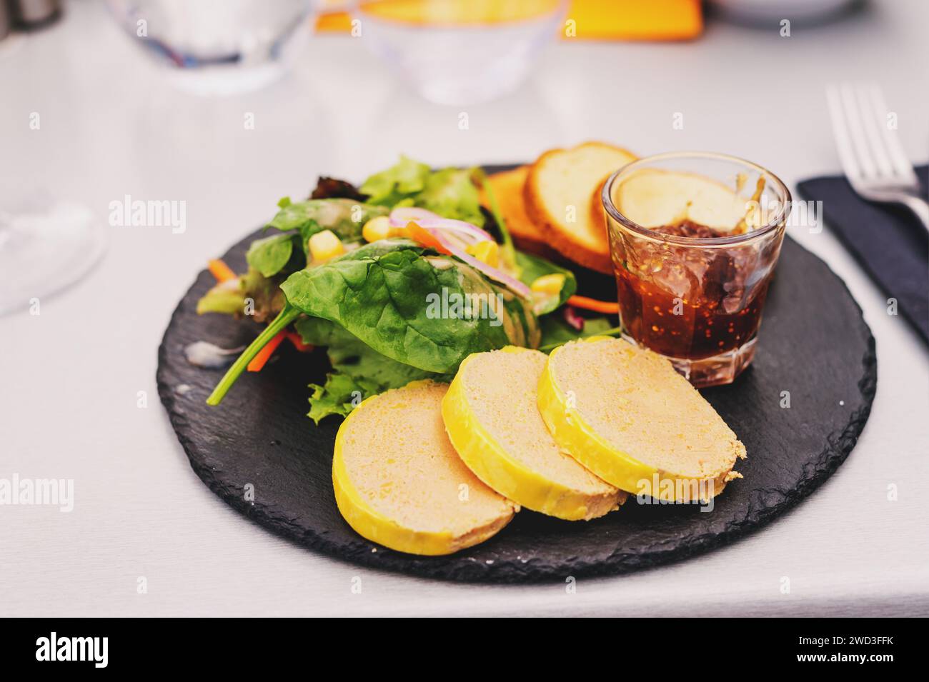 Foie gras salad with fig confiture served in the restaurant Stock Photo