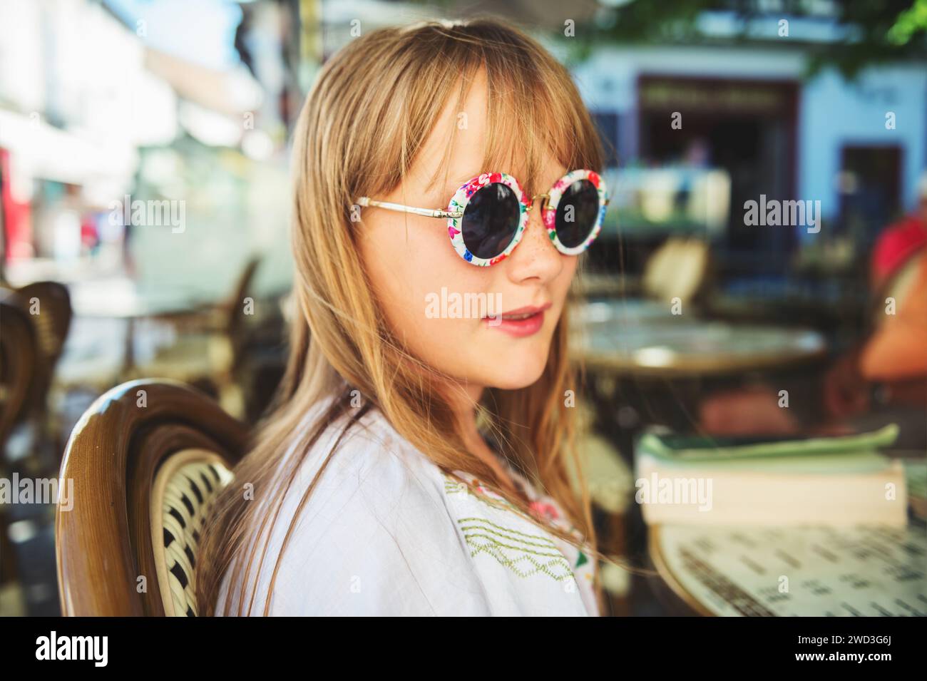 Outdoor close up portrait of adorable little girl wearing modern sunglasses Stock Photo