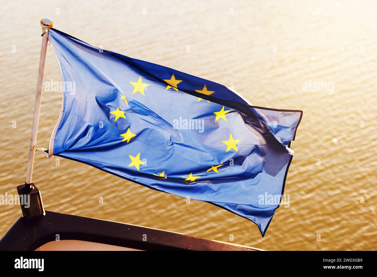 EU flag in front of a boat Stock Photo