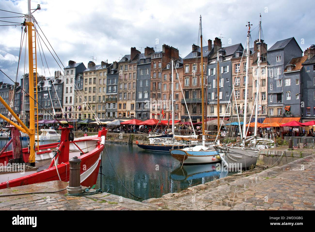 Honfleur, harbor basin with half-timbered houses and fishing boats Stock Photo