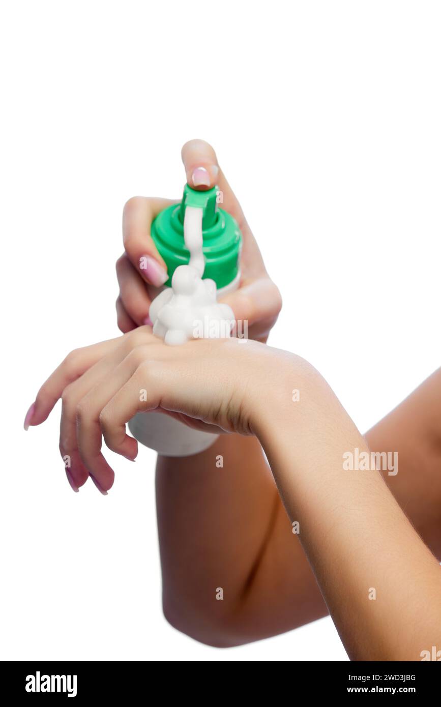 Cropped portrait of young woman using foamy facial care cosmetic product against white background. Stock Photo