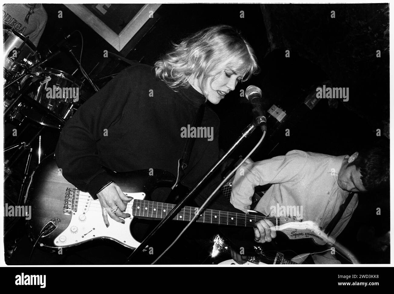 CATATONIA, CONCERT, 1994: A very young Cerys Matthews  of Catatonia playing live at the Legendary TJ’s in Newport, Wales, UK on 9 April 1994. Photo: Rob Watkins. INFO: Catatonia, a Welsh alternative rock band in the '90s, fronted by Cerys Matthews, gained fame with hits like 'Mulder and Scully' and 'Road Rage.' Their eclectic sound, blending pop, rock, and folk, solidified their place in the Britpop era, showcasing Matthews' distinctive vocals. Stock Photo