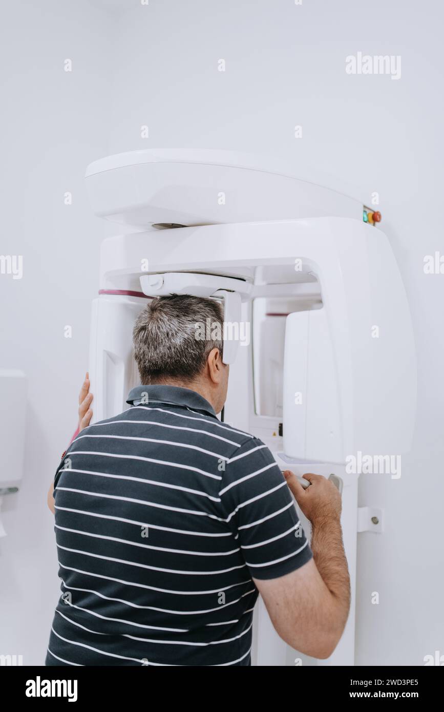Elderly man in a modern dental clinic undergoing a 3D teeth scan for